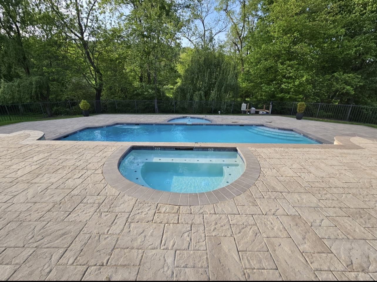 Pool and raised spa with new plaster, tile and natural stone coping