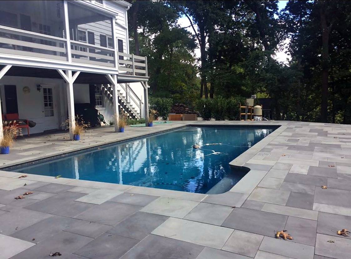 Rectangular pool with new bluestone coping and a full bluestone deck