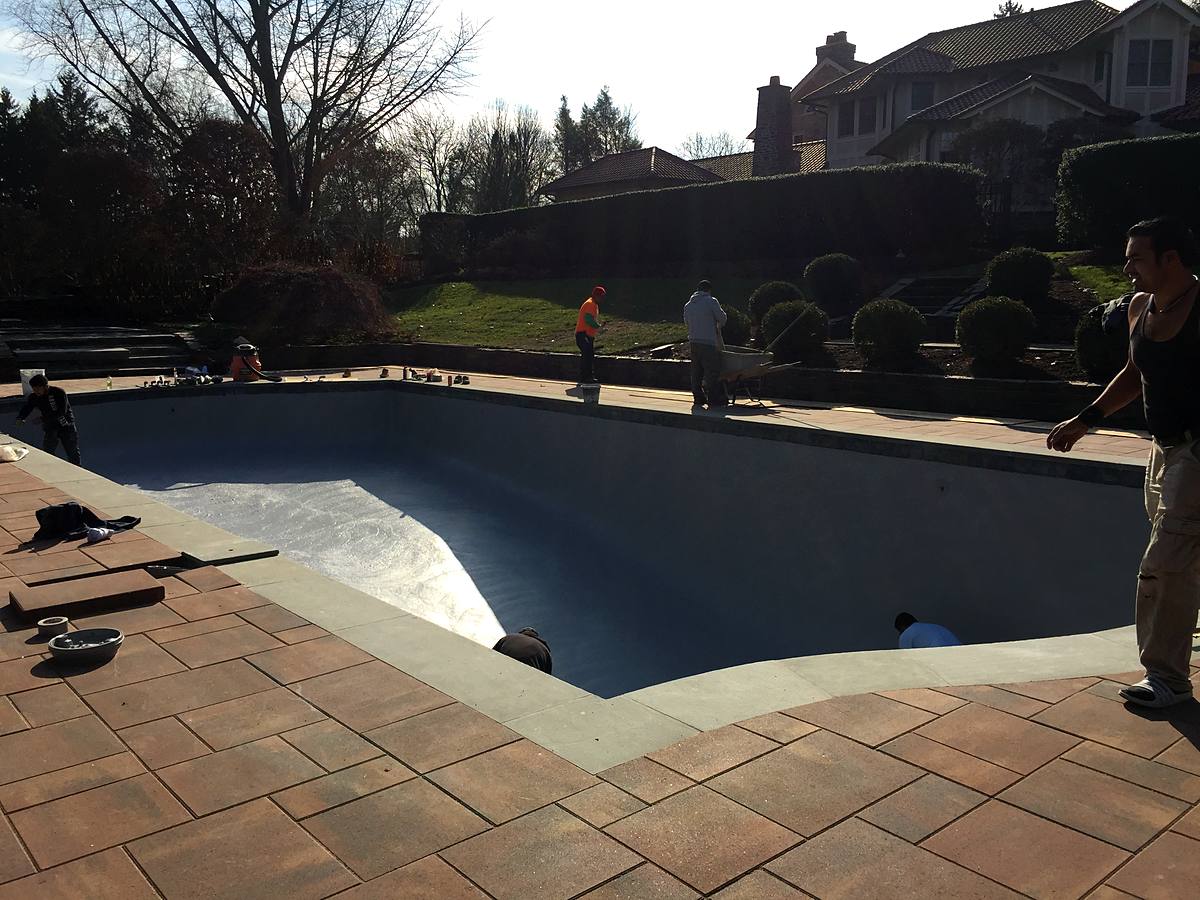Pool with bond coat applied, new paver deck in, waiting for plaster