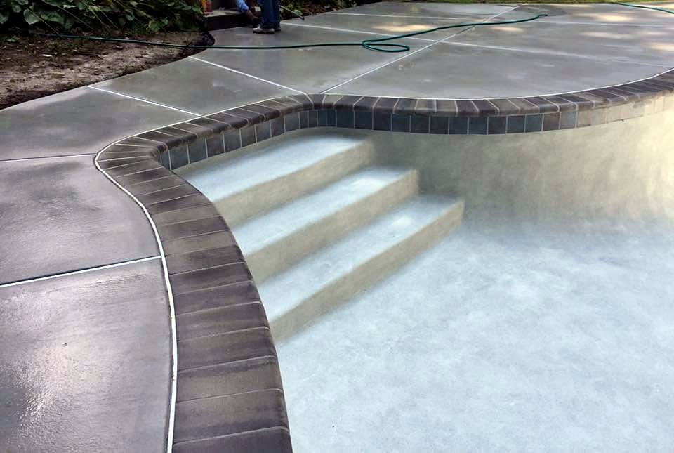 New brick coping set around pool steps, before plaster